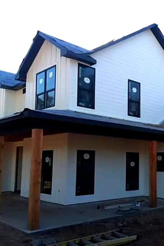 Two-storey white new build with dark windows